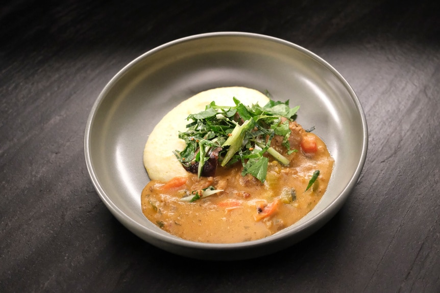 Michelle Wallace's Polish sausage étouffée with creamy grits for Top Chef