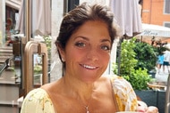 Kathy Wakile smiling while seated at a café.