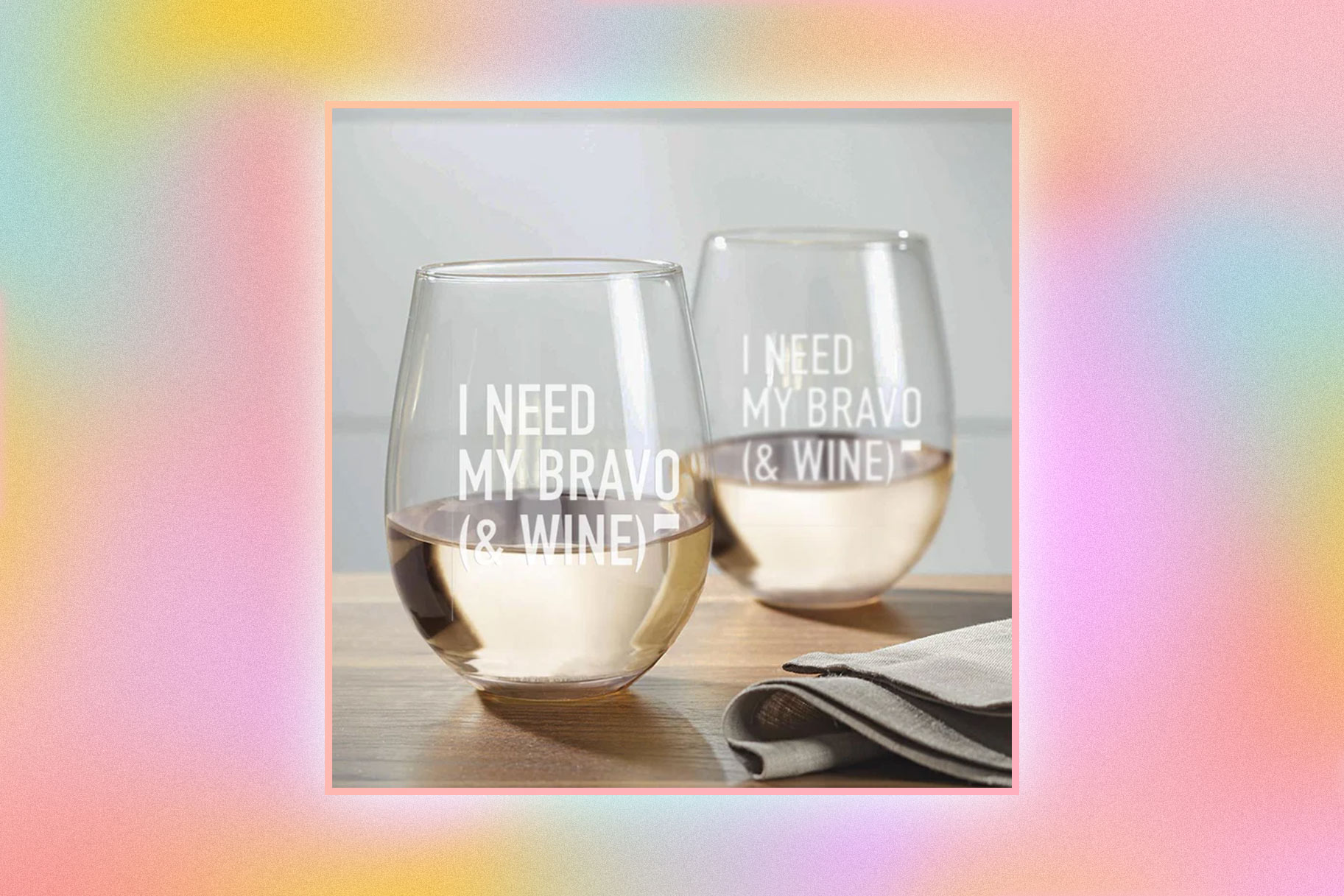 Wine glasses with a quote printed onto them overlaid onto a colorful background.