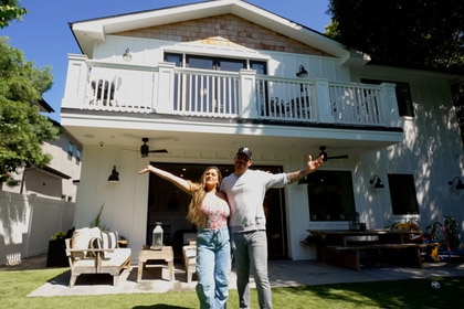Jax Taylor and Brittany Cartwright standing outside in their backyard.