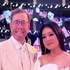 Crystal Kung Minkoff and Rob Minkoff posing together in all white at an event.