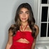 Gia Giudice wearing a red dress in her living room.