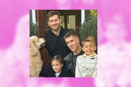 Fredrik Eklund with his husband, kids, and dog posing outdoors together for a family photo.