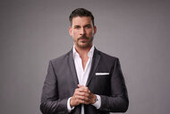 Jax Taylor in front of a gray backdrop for his press portrait for House of Villains.