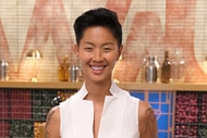 Kristen Kish wearing a white top in the Top Chef kitchen.