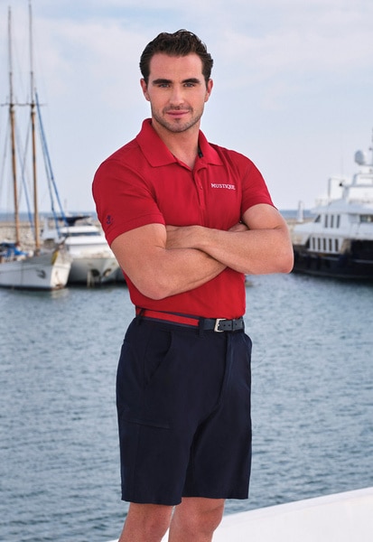 Joe Bradley wearing his yachting uniform on a boat marina