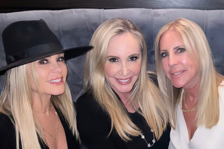 Tamra Judge, Shannon Beador, and Vicki Gunvalson smile together while sitting at a restaurant.