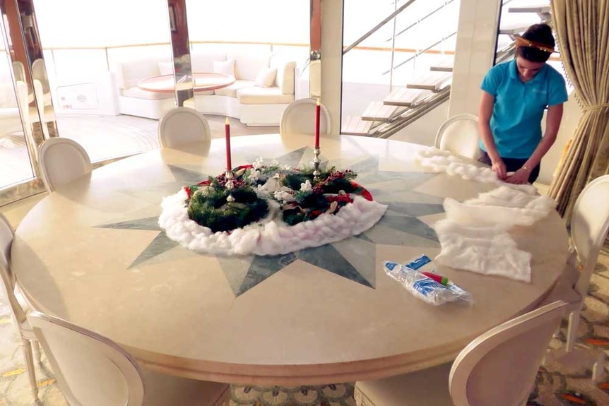 A yacht stewardess setting up a christmas party on the yacht