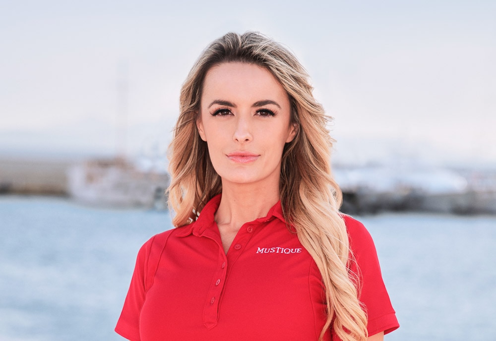 Elena Dubaich wearing a red polo on a boat marina