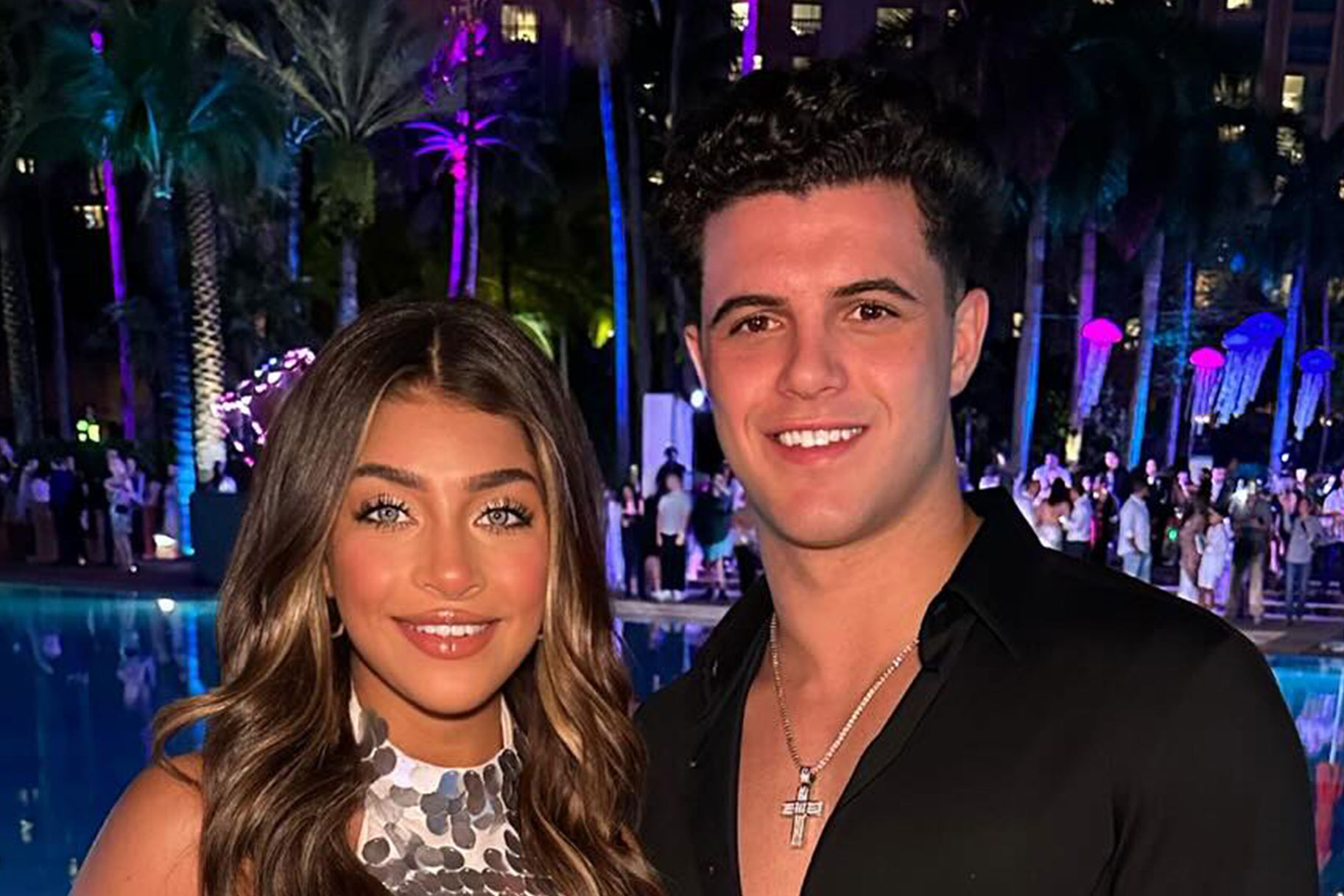 Gia Giudice and Christian Carmichael smiling in front of a pool.