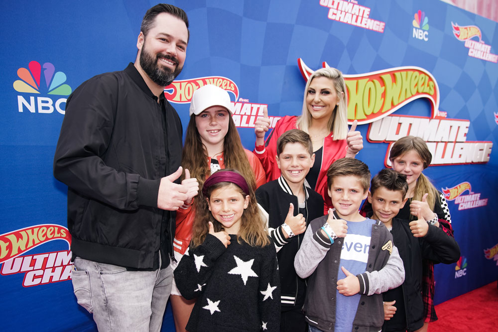 Travis Mullen and Gina Kirschenheiter with their children on red capet for "Hot Wheels: Ultimate Challenge"