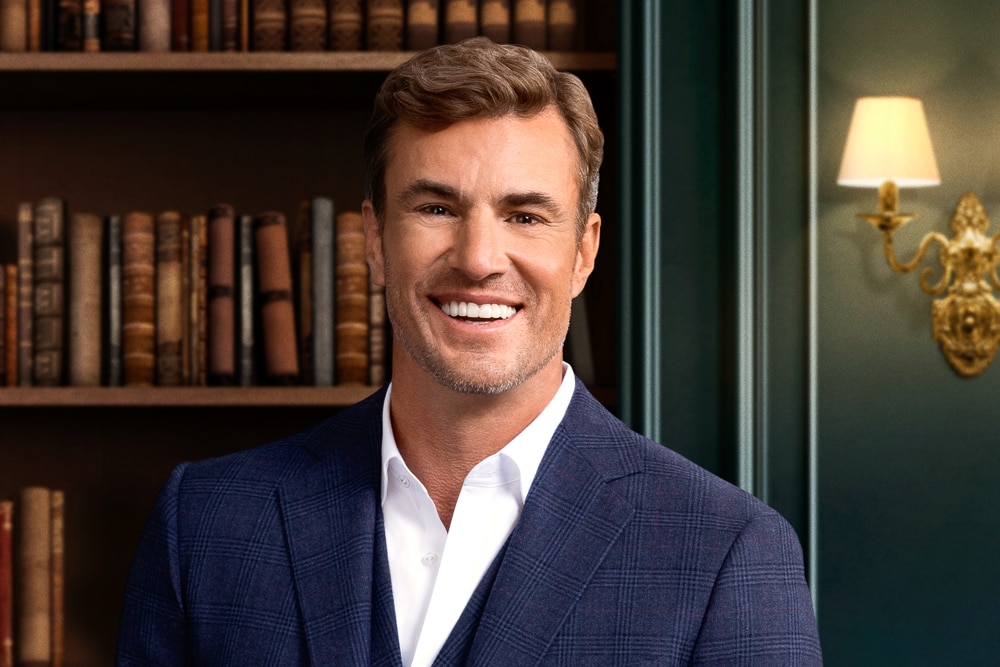 Shep Rose in front of a book shelf