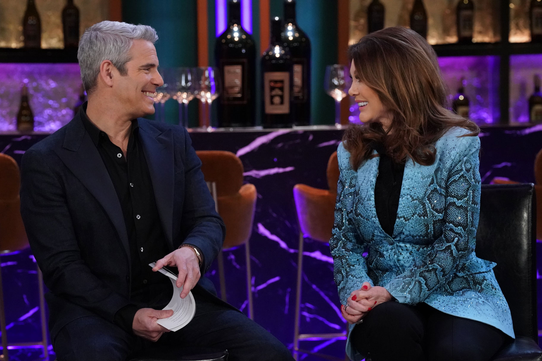 Andy Cohen and Lisa Vanderpump having a conversation together at a Vanderpump Rules reunion