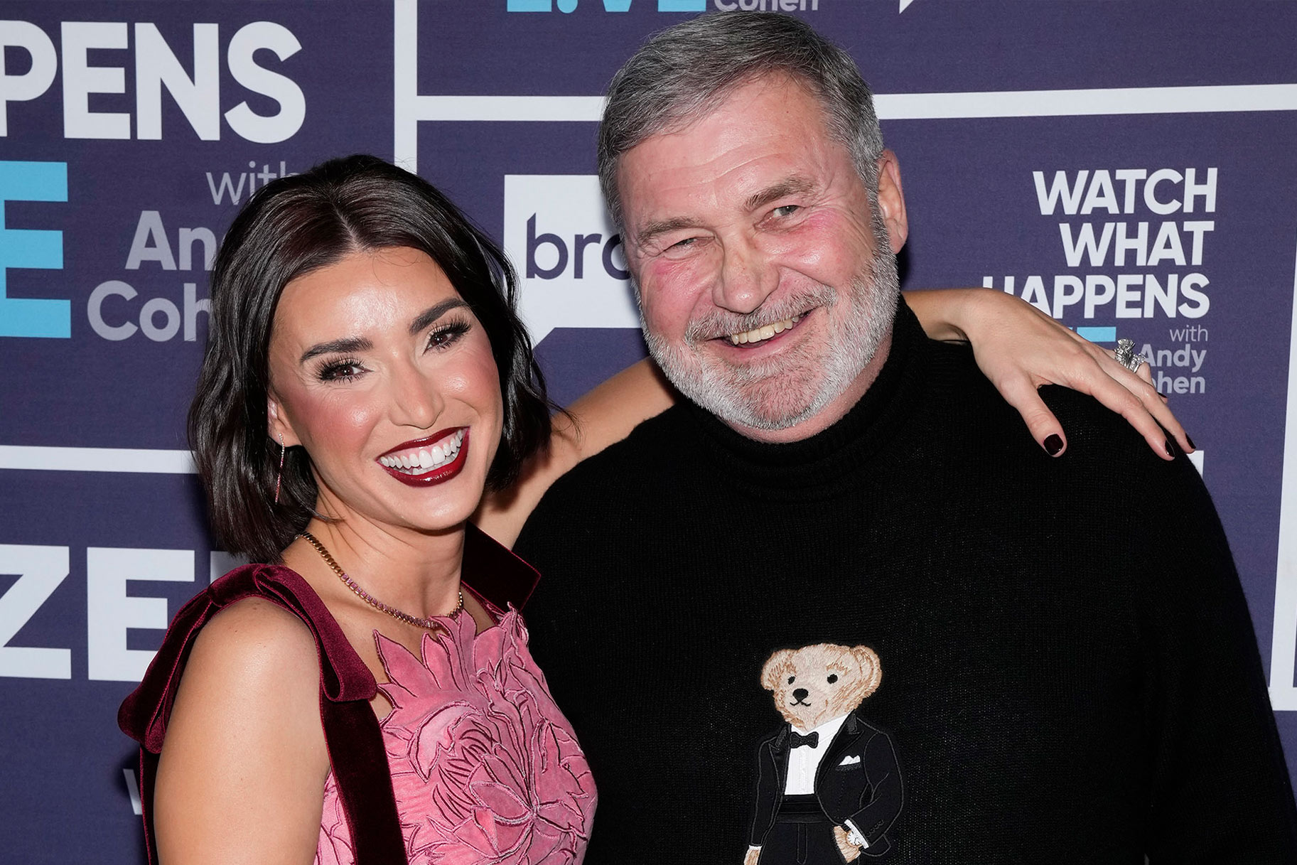 Bronwyn Newport and Todd Newport smiling in front of a step and repeat.