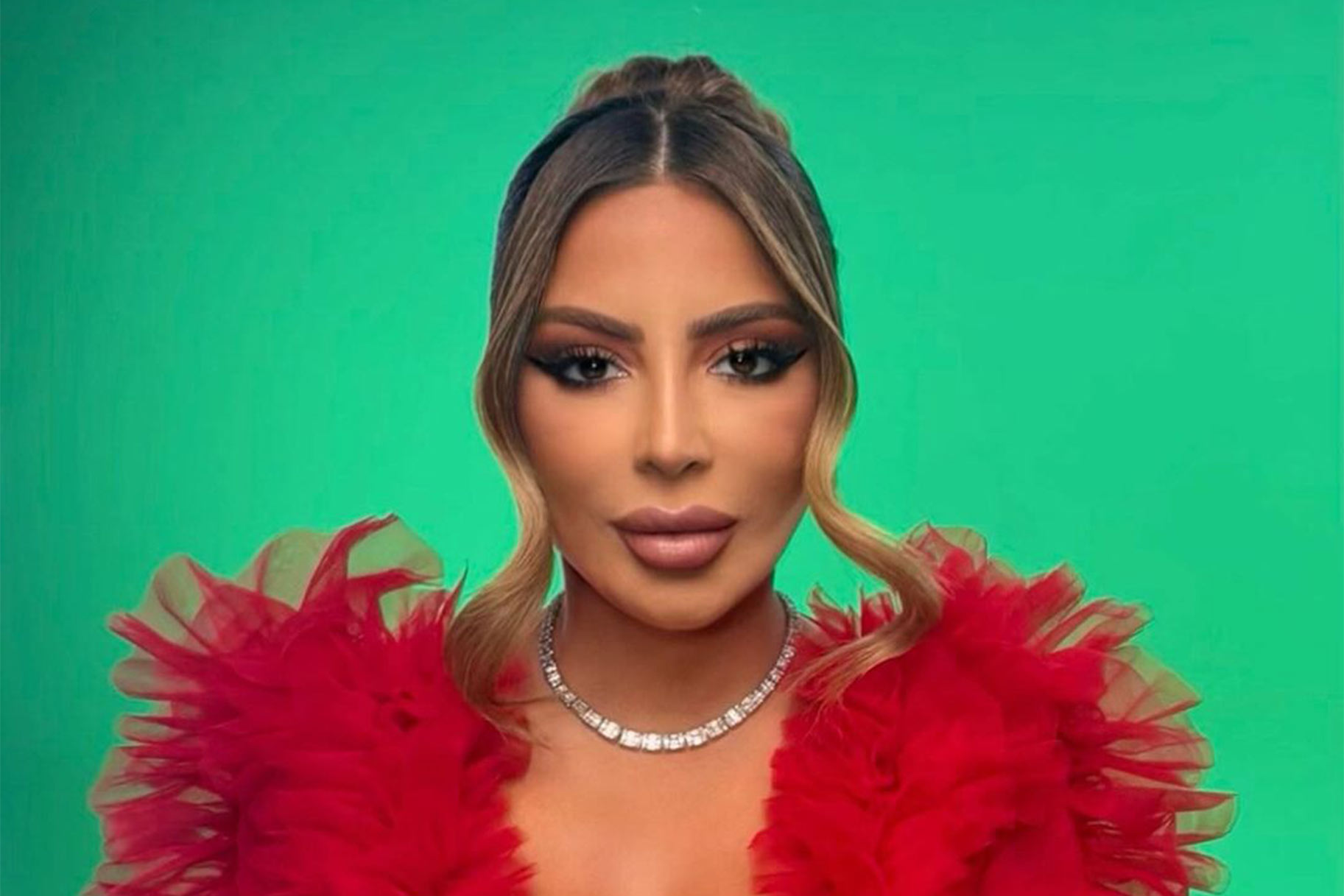 Larsa Pippen posing in front of a green screen.