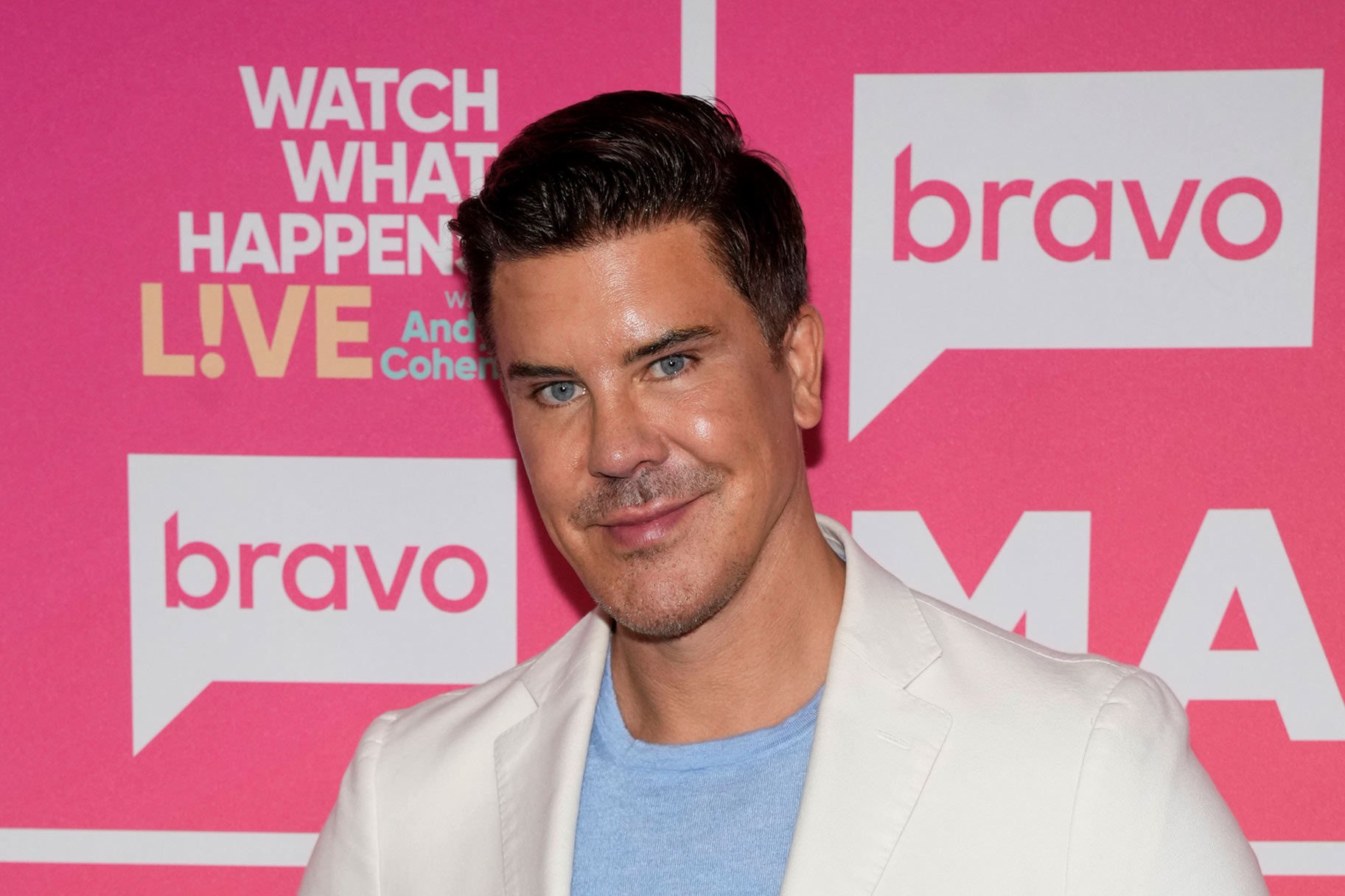 Fredrik Eklund smiling in front of a step and repeat.