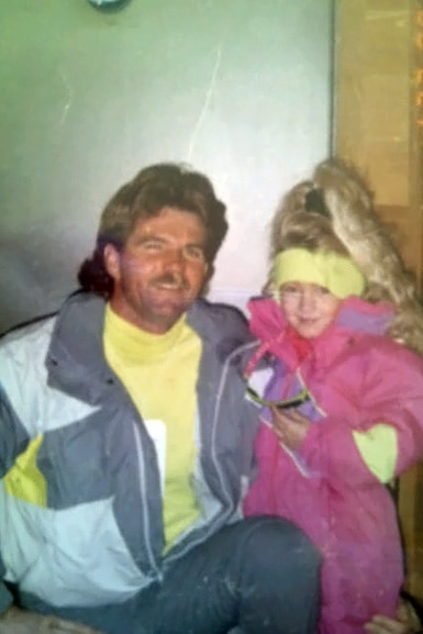 Heather Altman dressed in ski clothes at age five with her father