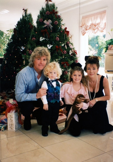 Lisa Vanderpump, Ken Todd, Pandora Vanderpump, and Max Todd smile together in front of a Christmas tree.