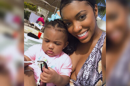 Porsha Williams holds her daughter Pilar Jhena and smiles