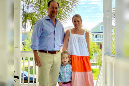 Jennifer Snowden with her partner Lee, and her son James Ascher together on a house porch.