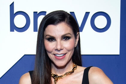 Heather Dubrow smiles on the red carpet of BravoCon