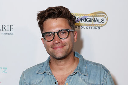 Tom Schwartz wearing a denim shirt while on the arrivals carpet for grand opening of The House of Barrie home goods store.