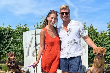 Kyle Cooke and Amanda Batula pose with their dogs in the Hamptons.