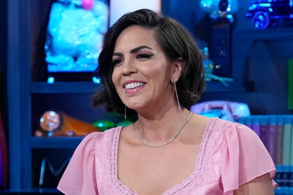 Katie Maloney smiles in a pink dress on Watch What Happens Live