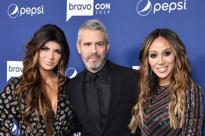 Teresa Giudice, Andy Cohen, and Melissa Gorga on a red carpet.