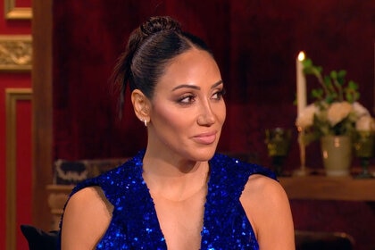 Melissa in a blue, sequins, hooded gown and an updo at the RHONJ reunion.