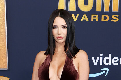 Scheana Shay waering a low punge dress at an event