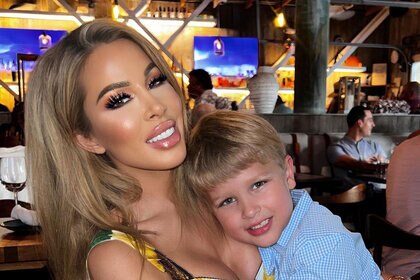 Lisa Hochstein and Logan hugging at a restaurant together.