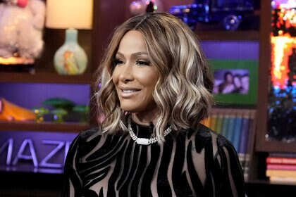 Sheree Whitfield sitting on set during a taping of Watch What Happens Live