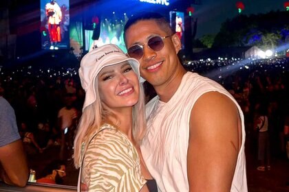 Ariana Madix and Daniel Wai pose together at a musical festival