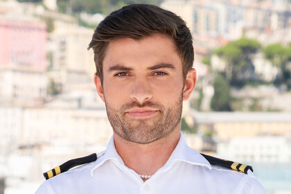 Luka in his uniform in front of the coastline.