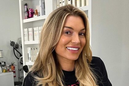 Lindsay Hubbard smiling inside of a hair salon after having her hair done.