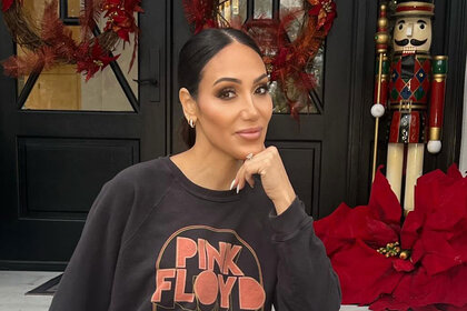 Melissa Gorga posing in front of her holiday decor on her front porch.