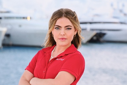 Sabrina Muller wearing a red polo on a boat marina