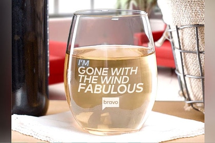 A wine glass on a table that reads "I'm Gone With The Wind Fabulous"
