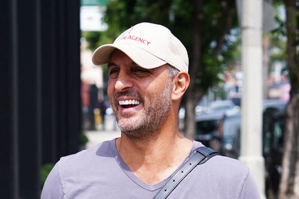 Mauricio Umansky smiling while walking down a street.