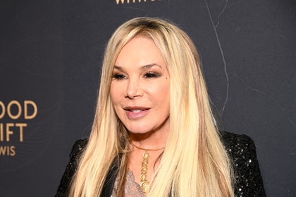 Adrienne Maloof posing in front of a step and repeat.