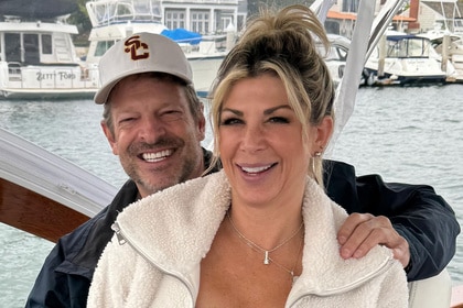 Alexis Bellino and John Janssen smiling together on a boat.