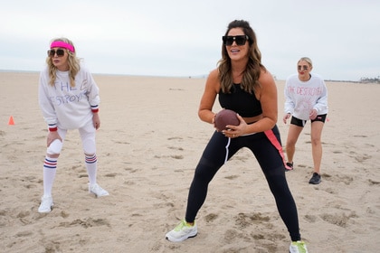 Emily Simpson, Shannon Beador and Gina Kirschenheiter playing flag football on a beach