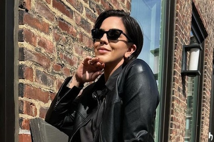 Katie Maloney on a balcony wearing a black leather jacket