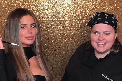 Brielle Biermann and Chef Tracey Bloom posing together in front of a backdrop.