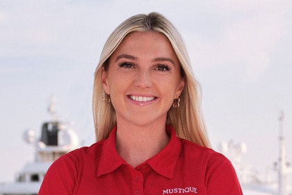 Carrie O'Neill smiling on the Mustique yacht in her uniform.