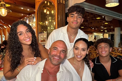 Melissa Gorga posing with her family inside of a restaurant.