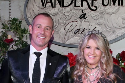 Pandora Vanderpump Sabo and Jason Sabo smiling together in front of a step and repeat.