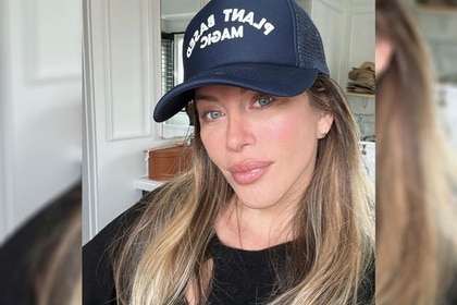 Dina Manzo wearing a black top and a trucker hat