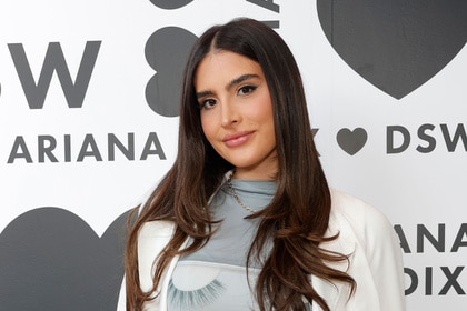 Sophia Umansky posing in front of a step and repeat.